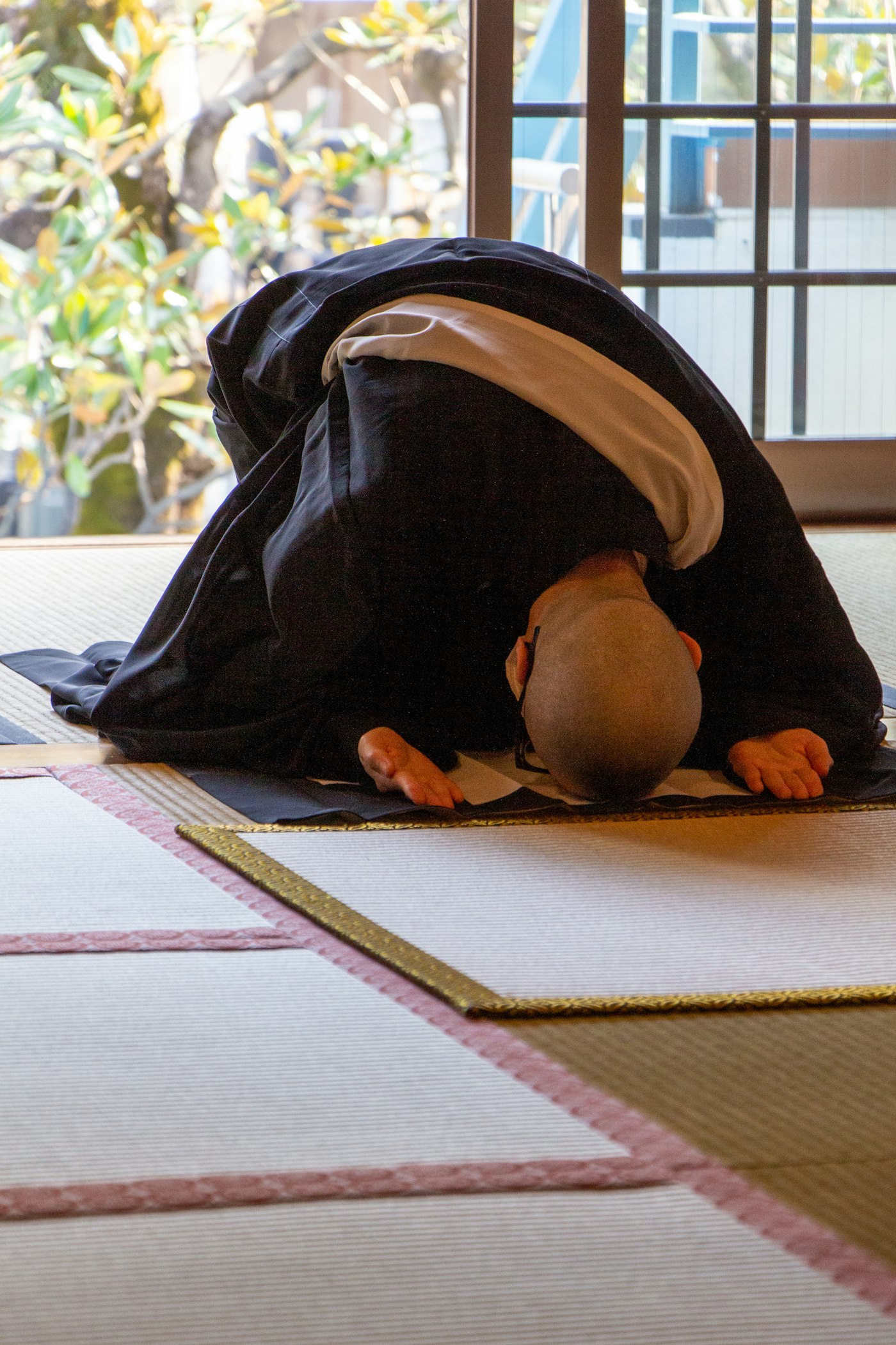 People bowing greeting each other on a quiet Japanese street in Tokyo