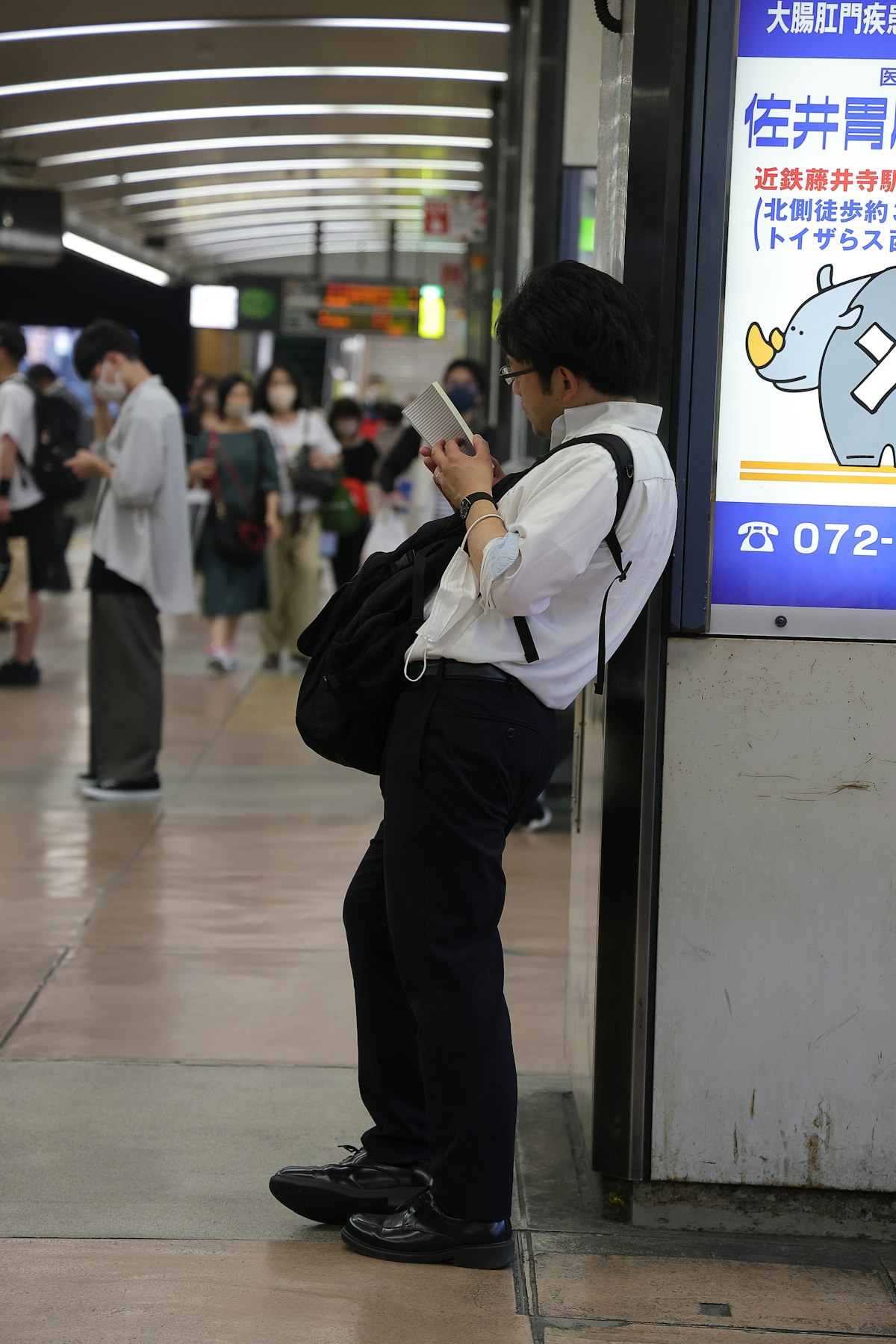 Traveler using smartphone at Japan train station