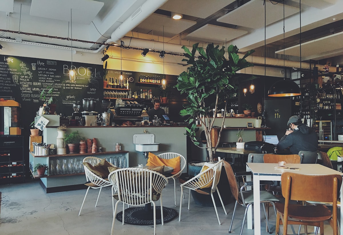 Tourists using free WiFi at Japanese cafe hotspot with laptops and phones