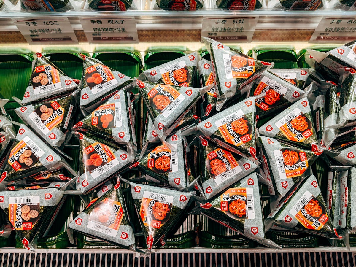 Packaged onigiri rice balls on Japan convenience store shelf various flavors nori