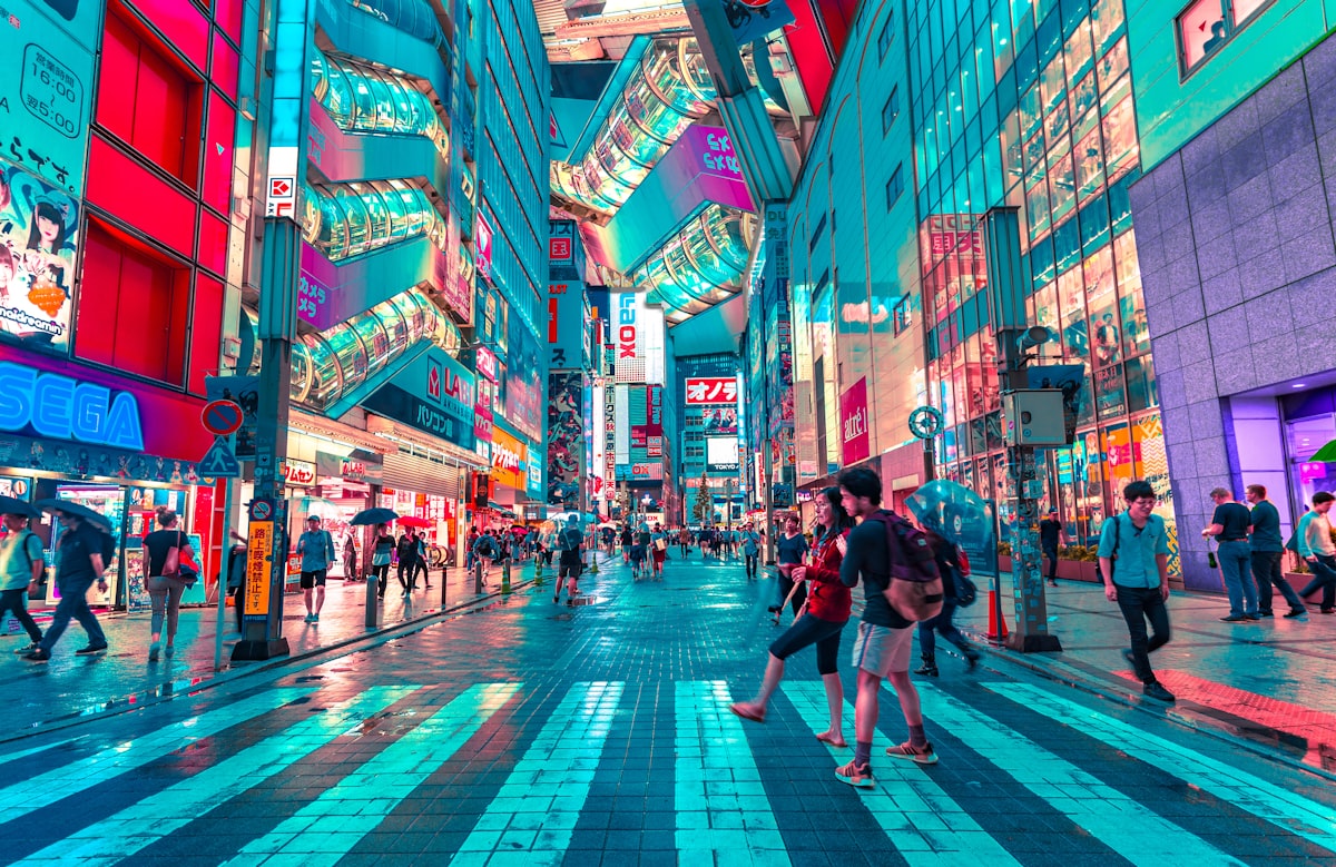 Tourist using smartphone in Tokyo at night with neon signs